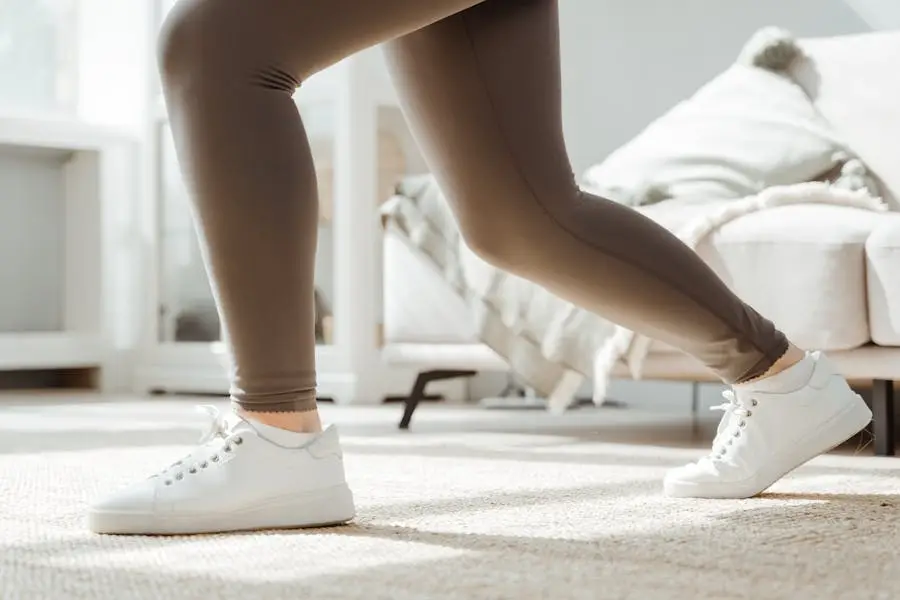 Close-up of a woman stretching at home in sportswear and sneakers.